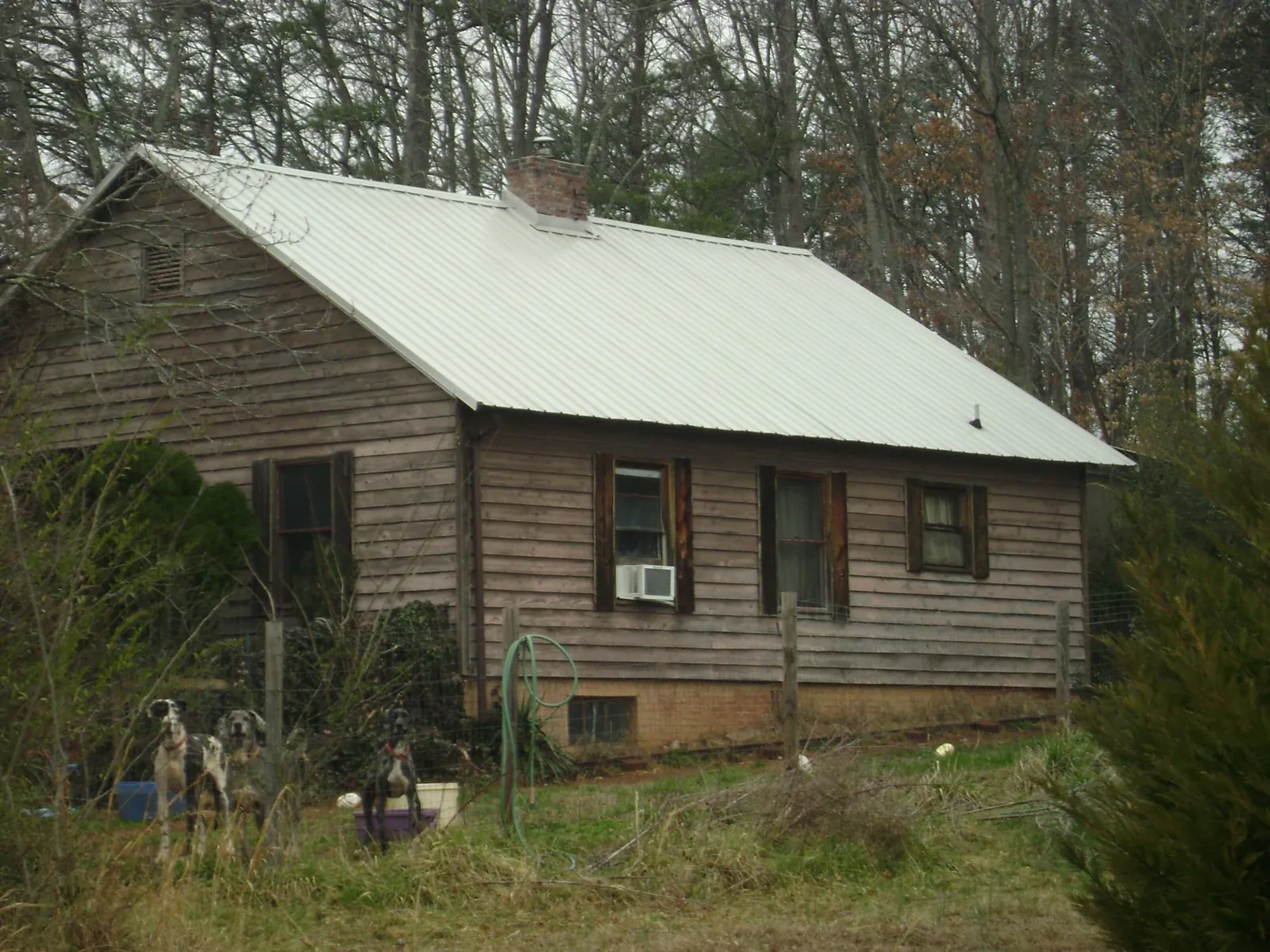White metal roof on an old wood sided farmhouse, from a Metal Roof Installation job in Camillus